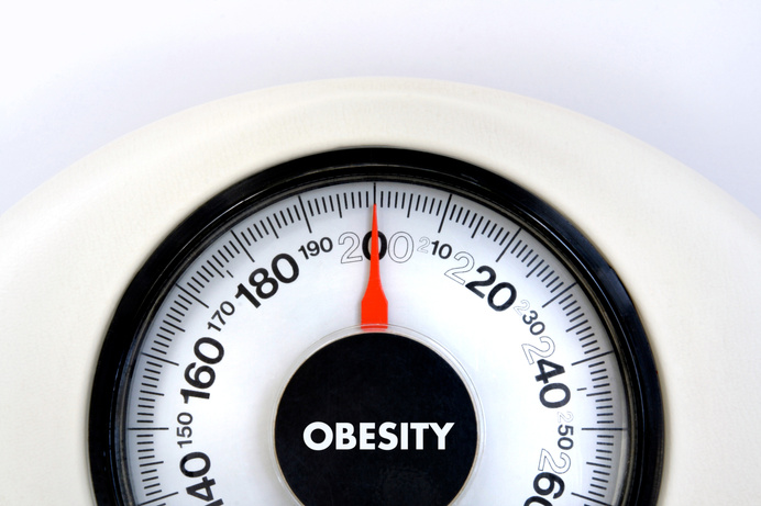 Weighing Scale with Obesity Text Closeup